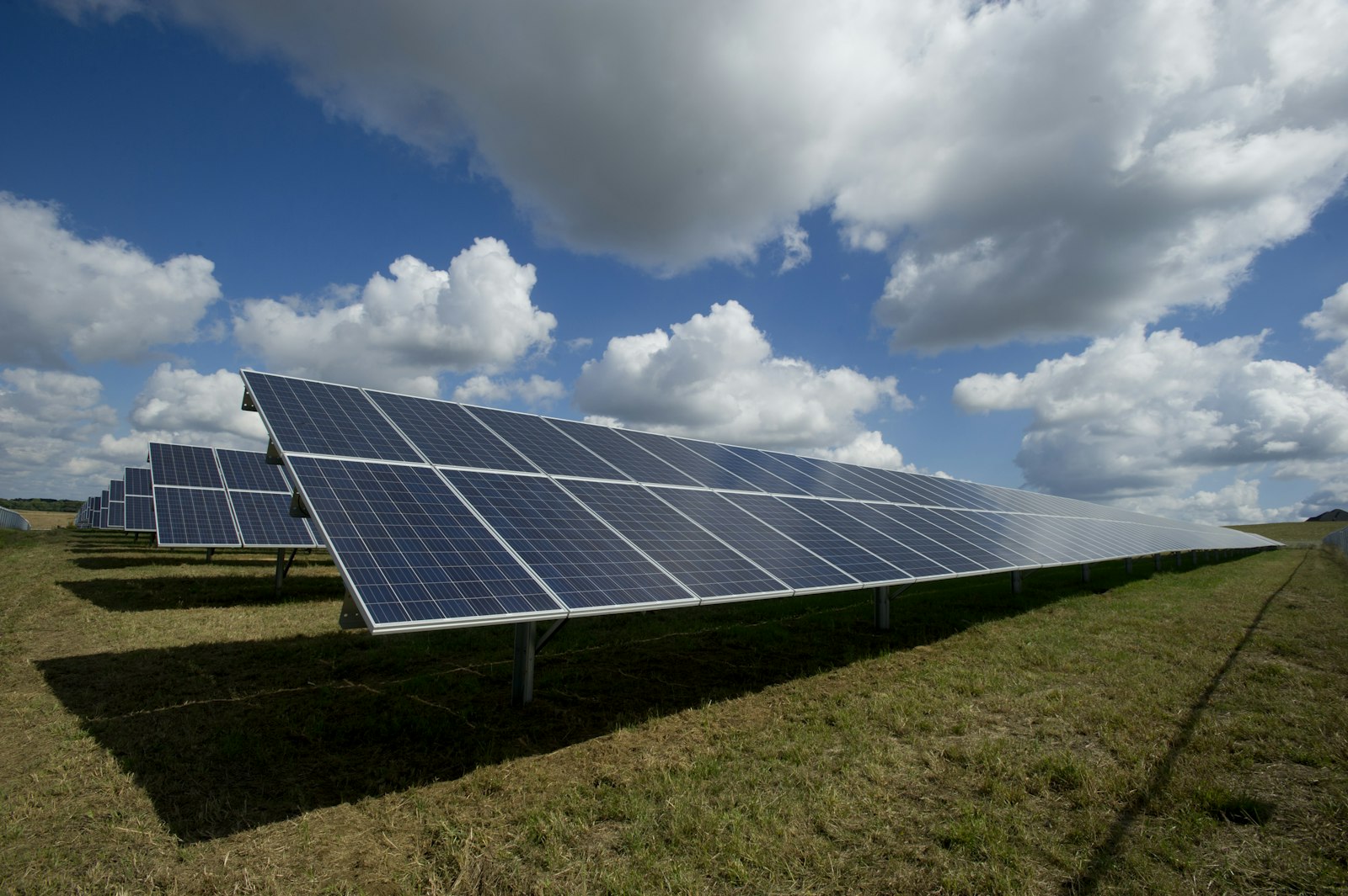 Solar panels and green mountains on a clear day in Spain